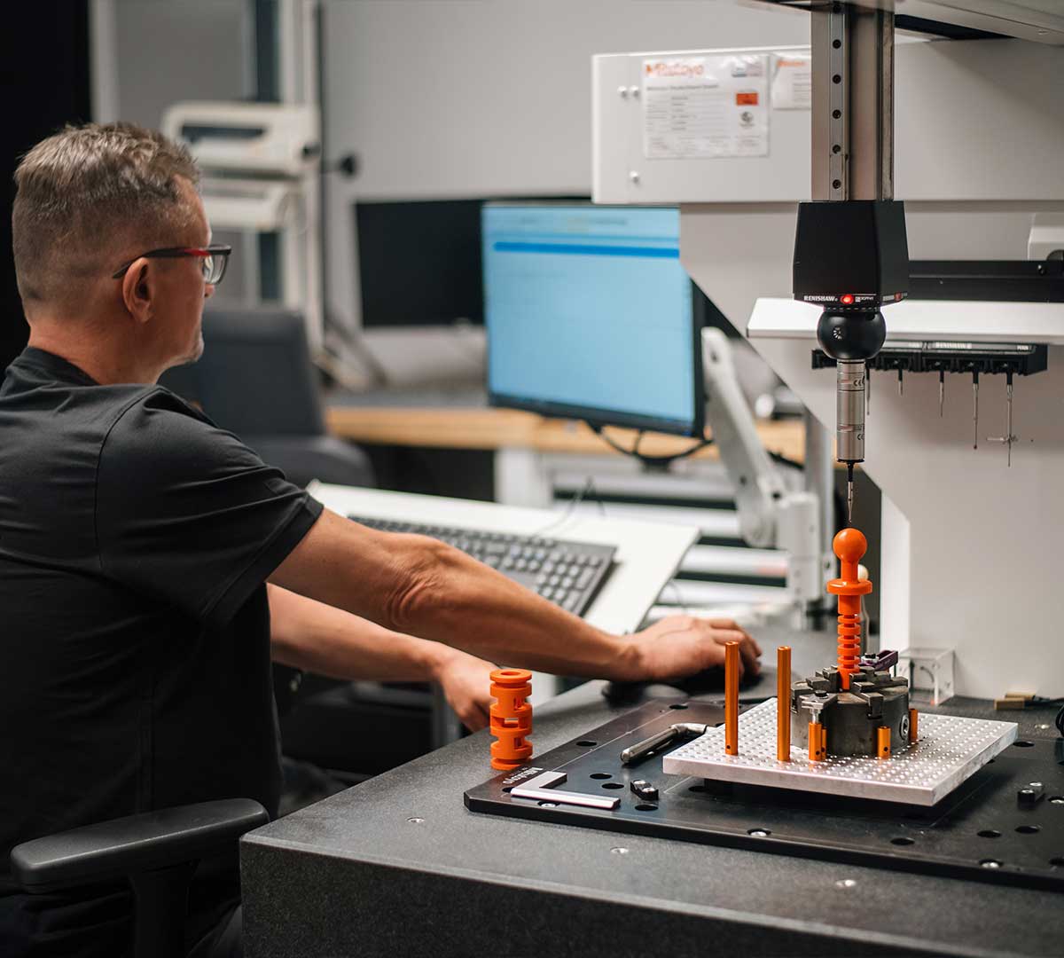 Mitarbeiter an der 3D-Koordinatenmessmaschine bei der Prüfung eines Bauteils